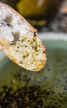 Load image into Gallery viewer, Close-up of a slice of bread with herbs on a rustic background